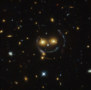 An image of galaxies that contains a "happy face" with two eyes and a smiling mouth