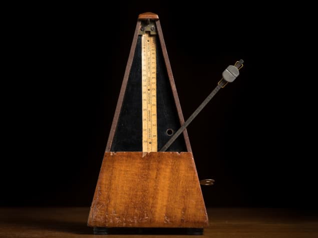 A photo of a metronome showing the weight and pendulum