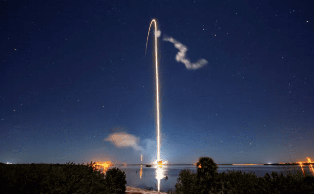 Photo of a Starlink launch, showing a bright streak across the night sky