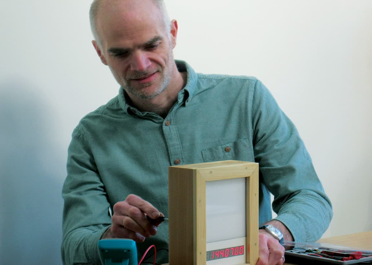 Photo of Andrew Ferguson with a muon detector