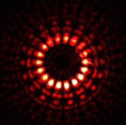 A highly-structured burst of light forming a series of concentric rings of periodic light and dark areas