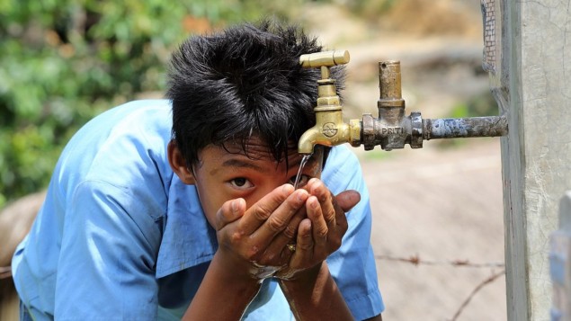 Photo of a boy enjoying clean drinking water