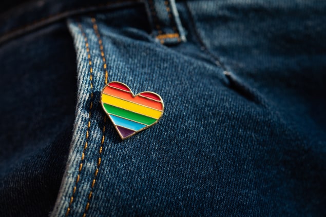 Rainbow colour LGBTQA heart badge on jeans.