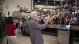 Former CERN DG Rolf-Dieter Heuer signalling to the audience at the Higgs boson discovery seminar on 4 July 2012