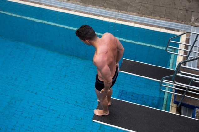 Photo of man worried about diving into a pool