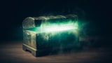 Pandoras box with green smoke on a wooden background