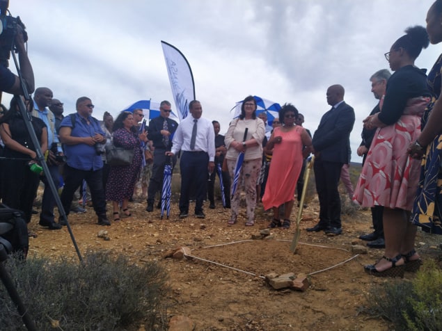 A crowd of officials at the site of the new facility