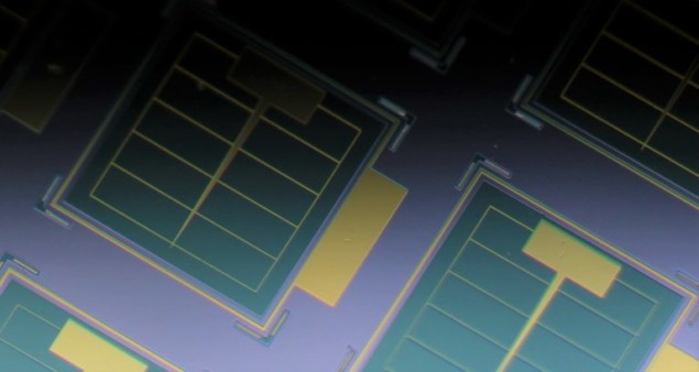 Photo of ultrathin on-chip solar cells fabricated from a stack of semiconducting materials. The cells are coloured as green squares and include an ultrathin layer of light-absorbing GaAs, which is key to their radiation tolerance