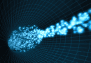 A graphic representation of a particle beam in an accelerator. The beam appears as a jet of bright blue dots flying through black space marked with blue grid lines