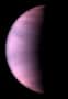 Image of clouds on the planet Venus. The planet is shown half in darkness, and the clouds appear in this ultraviolet-light image as a hazy, pink-purple colour