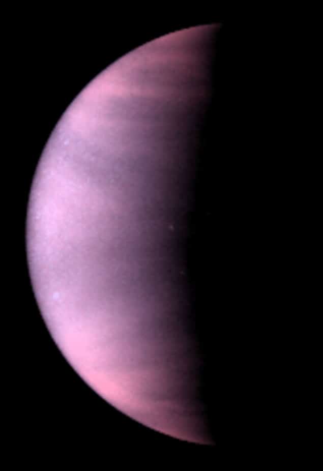 Image of clouds on the planet Venus. The planet is shown half in darkness, and the clouds appear in this ultraviolet-light image as a hazy, pink-purple colour