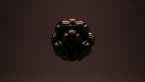 Image of a group of dark spheres balled together against a dark background