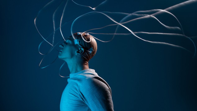 Man with shaved head covered with electrodes