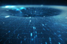 Artist's representation of a black hole, showing light streaming into a hole overlaid with grid lines