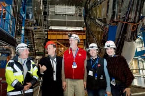 A group of people including Tom Hanks in front of the ATLAS detector at CERN