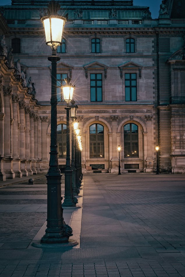 A row of gas lamps outside the Louvre in Paris