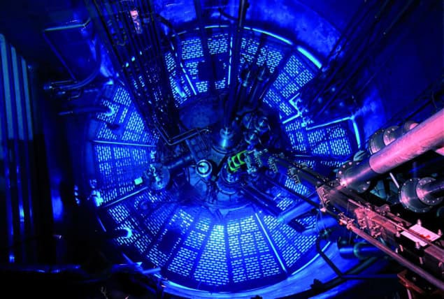 Looking down into the reactor pool lit in blue