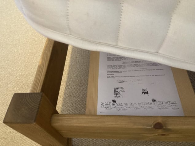 A photo of Brian Josephson's paper on mattress rotation, located below a mattress being lifted up for rotation