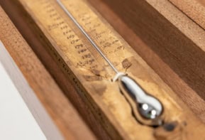 Old wood and mercury thermometer with a scale hand drawn along its length