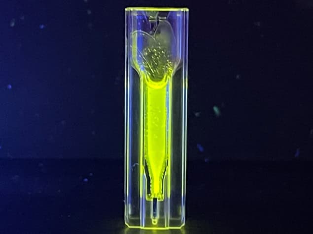A small vial containing fluorescent yellow supraparticles