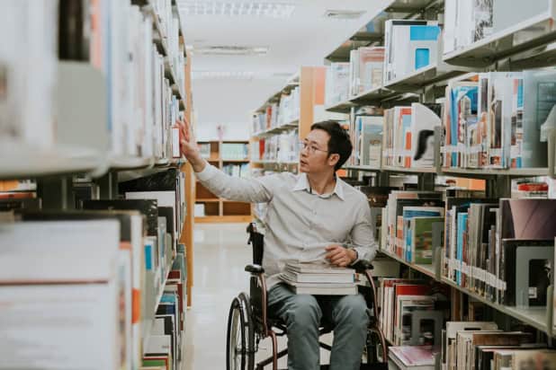 Person in wheelchair in a library