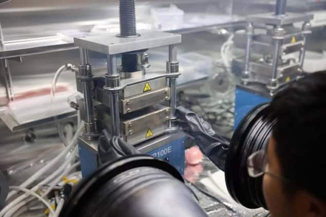 A researcher conducts research on two-dimensional metals Photo of a researcher working in a glovebox