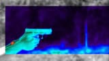 infrared image of hands holding a gun