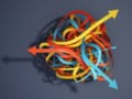 A ball of red, yellow and blue ribbons with arrows on the ends that point in different directions