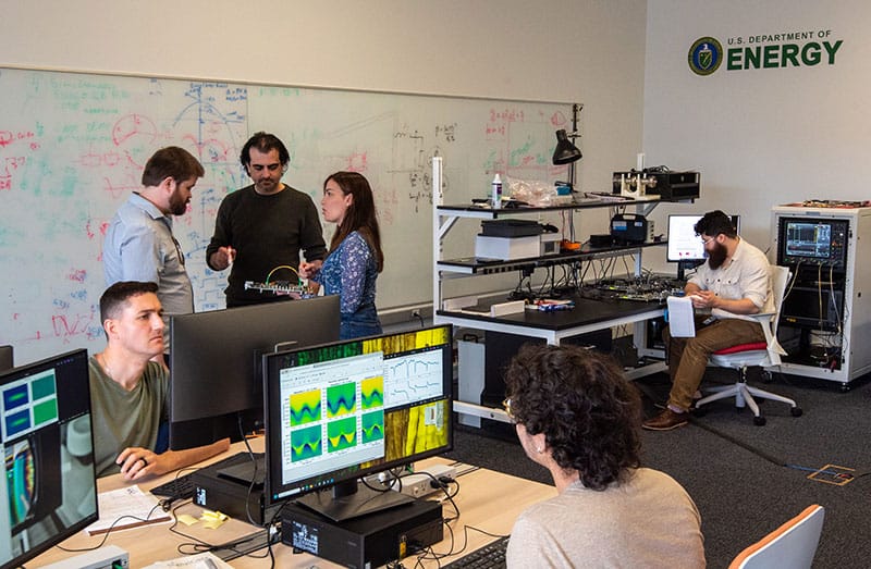 Researchers in the control room of the SQMS Quantum Garage facility