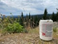 A photo of a portable seismometer outdoors with trees and grass in the background