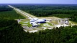 Aerial photo of a scientific facility with two long "arms" at right angles