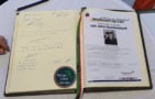 Photo of book with signatures of Nobel laureates at the Helgoland 2025 meting.