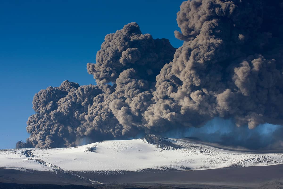 Billows of black smoke above a volcano