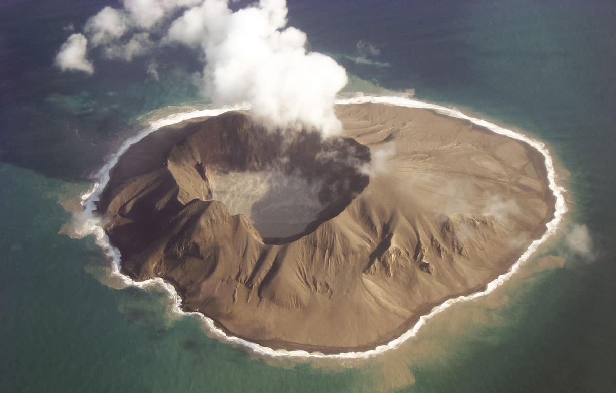 A volcanic island venting smoke