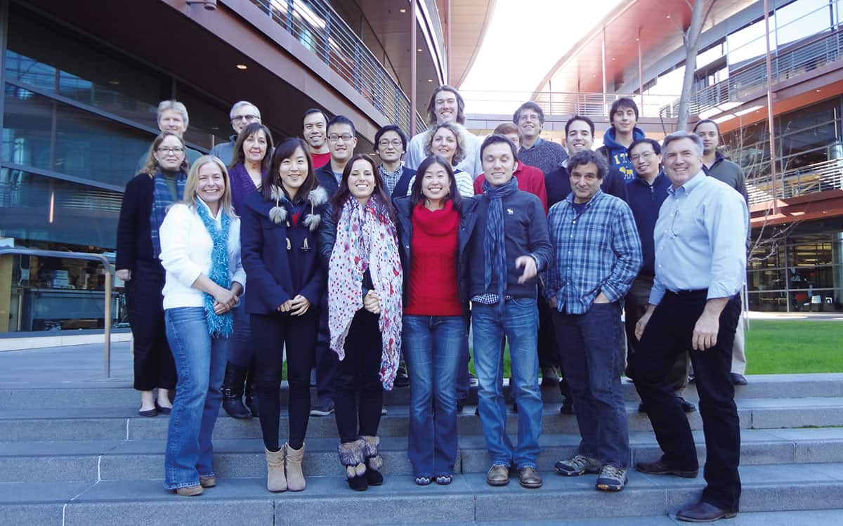 A group of men and women in front of a office building