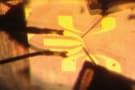 A thin glass needle placed near a 2 mm-wide diamond substrate
