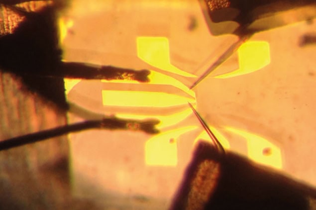 A thin glass needle placed near a 2 mm-wide diamond substrate