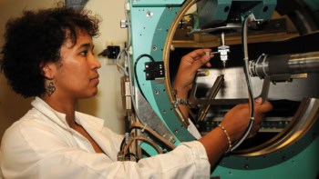 Woman of colour using a scientific instrument