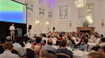 Man on stage in a conference venue
