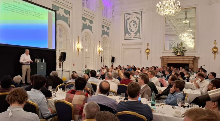 Man on stage in a conference venue