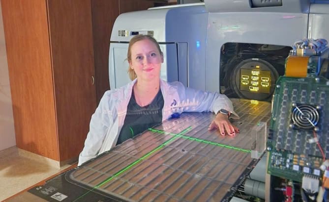 Medical physicist Jacqueline Andreozzi next to a linac
