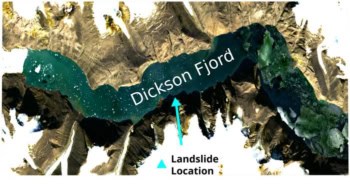 Satellite image of a narrow, winding passage of deep green sea (labelled "Dickson Fjord") surrounded by land that is a mixture of bare brown rock and white snow. A blue arrow indicates the location of the landslide