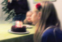 Girl blowing out the candles on a birthday cake