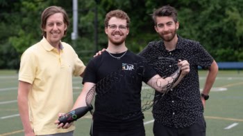 Three researchers with their new parachute