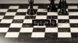 GCHQ spelt out in Scrabble pieces on a chess board