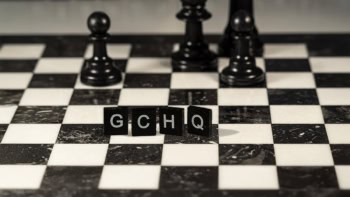 GCHQ spelt out in Scrabble pieces on a chess board