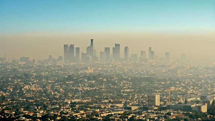 Wide shot of the downtown Los Angeles skyline bathed in smog. View from Griffith Park