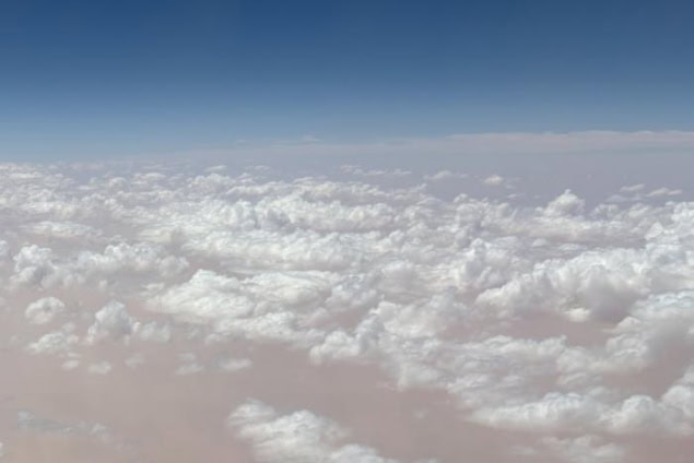 Photo of a thin layer of puffy ice clouds seen from just above, as from an aeroplane