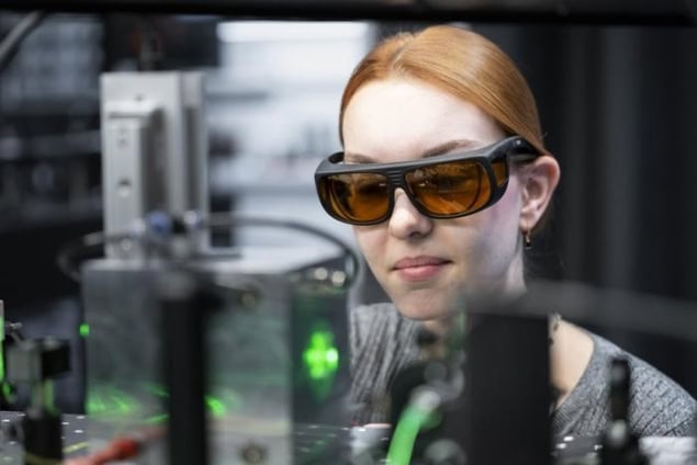 Photograph of the optical-tweezers and a member of the research team