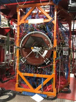 Photo of the "Crystal Ball" detector, which is housed in a large rectangular orange metal frame. There are lots of wires coming out of it.